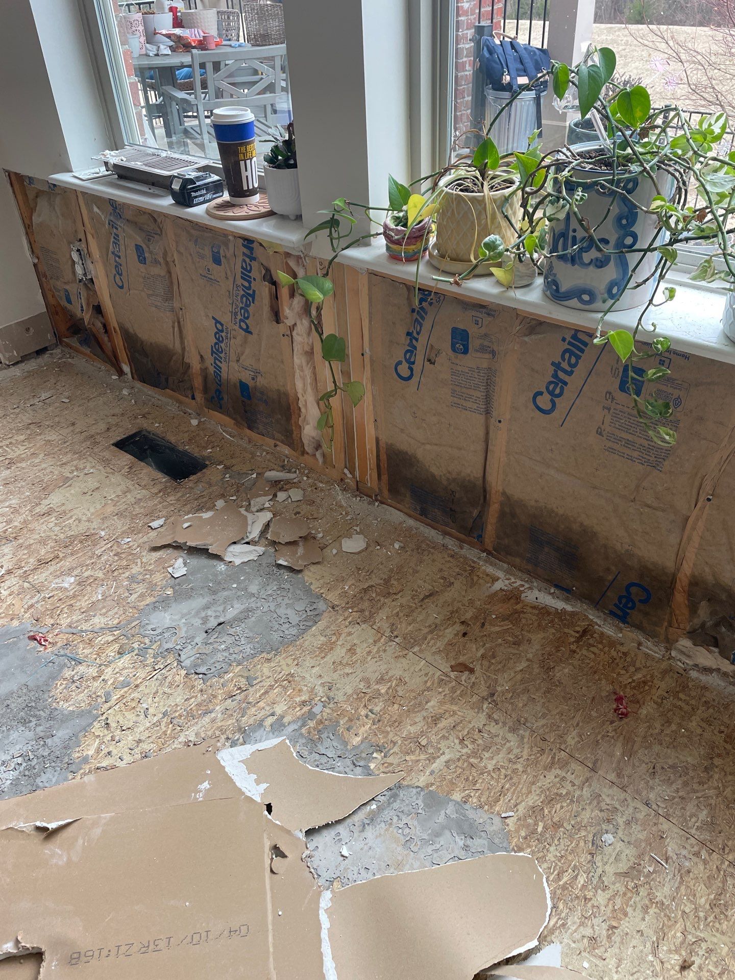 Damaged wall insulation and subfloor after storm damage in Louisville