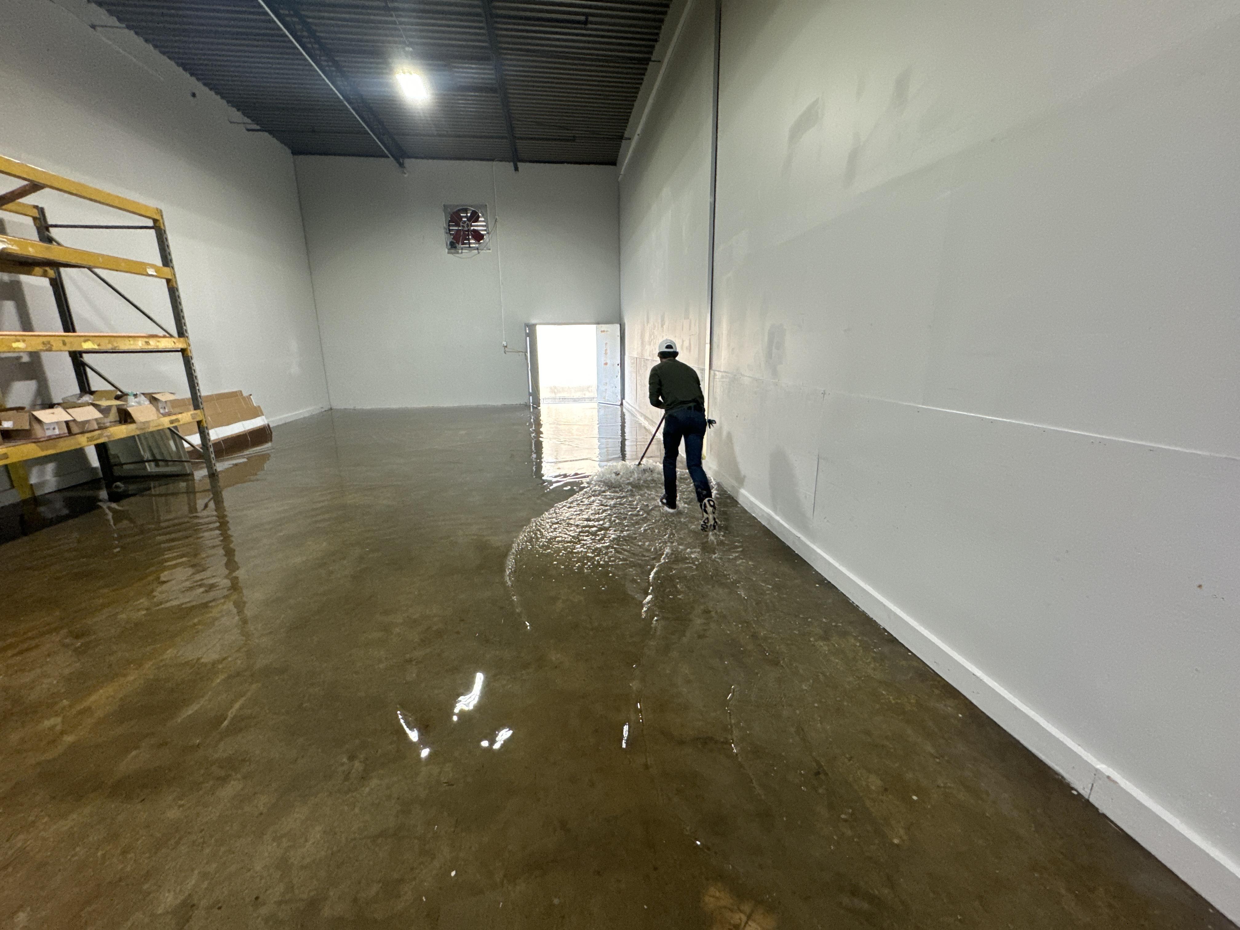 IRS crew member extracting standing water from a Louisville commercial building