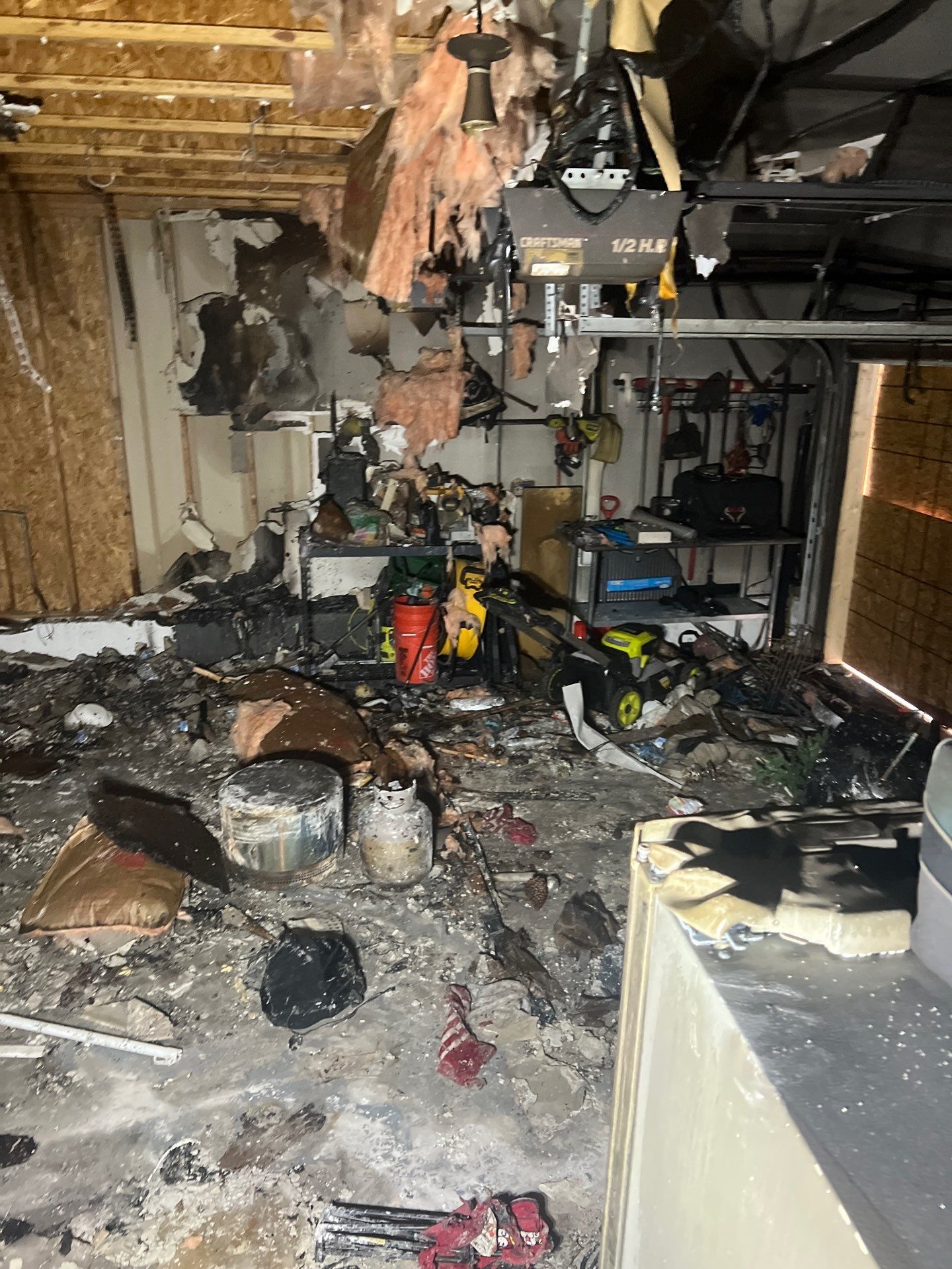 Extensive fire damage inside a Louisville garage cleared by IRS crew